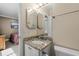 Well-lit bathroom with granite countertop, white cabinetry, and a unique beveled mirror at 108 N Ocean Blvd. # 301, North Myrtle Beach, SC 29582