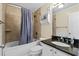 Bright bathroom featuring a shower-tub combination, updated vanity and decorative shelf at 108 N Ocean Blvd. # 301, North Myrtle Beach, SC 29582