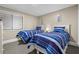 Cozy bedroom with two beds, striped bedding, neutral walls, and a window for natural light at 108 N Ocean Blvd. # 301, North Myrtle Beach, SC 29582