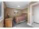 Bedroom with a decorative wood headboard, wall art, and neutral carpet with ample sunlight at 108 N Ocean Blvd. # 301, North Myrtle Beach, SC 29582