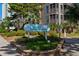 Community sign for Tilghman Beach & Racquet Club, surrounded by lush landscaping at 108 N Ocean Blvd. # 301, North Myrtle Beach, SC 29582