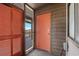 Open entryway with orange doors and a screen door leading to an outdoor patio area at 108 N Ocean Blvd. # 301, North Myrtle Beach, SC 29582