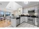 Modern kitchen with stainless steel appliances, black granite countertops, and white cabinetry at 108 N Ocean Blvd. # 301, North Myrtle Beach, SC 29582