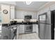 Updated kitchen with stainless steel appliances, granite counters, and white cabinetry for a clean and modern feel at 108 N Ocean Blvd. # 301, North Myrtle Beach, SC 29582