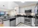 Modern kitchen featuring stainless steel appliances, sleek granite countertops, and crisp white cabinets for stylish cooking at 108 N Ocean Blvd. # 301, North Myrtle Beach, SC 29582