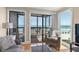 Cozy living area with ocean view windows and access to a screened in porch at 108 N Ocean Blvd. # 301, North Myrtle Beach, SC 29582