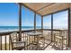 Relaxing screened-in porch with table and chairs, overlooking the ocean for serene outdoor living at 108 N Ocean Blvd. # 301, North Myrtle Beach, SC 29582
