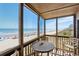 Enjoy ocean views from the screened-in porch featuring a table and chairs for outdoor relaxation at 108 N Ocean Blvd. # 301, North Myrtle Beach, SC 29582