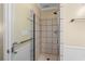 Updated shower with tiled surround, glass door, and modern showerhead and fixtures at 108 N Ocean Blvd. # 301, North Myrtle Beach, SC 29582