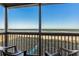 A screened-in balcony features ocean views and seating for relaxing by the sea at 108 N Ocean Blvd. # 308, North Myrtle Beach, SC 29582