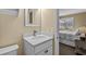 Bright bathroom featuring a white vanity with a modern faucet and a decorative mirror next to the bedroom at 108 N Ocean Blvd. # 308, North Myrtle Beach, SC 29582
