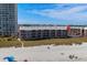 Beachfront condo exterior shot featuring balconies and complex pool at 108 N Ocean Blvd. # 308, North Myrtle Beach, SC 29582