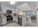 Open kitchen with bar overlooking the oceanfront living and dining space at 108 N Ocean Blvd. # 308, North Myrtle Beach, SC 29582