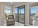Bright living room with ocean views, a comfortable armchair, and sliding glass doors to the balcony at 108 N Ocean Blvd. # 308, North Myrtle Beach, SC 29582