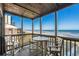 Relaxing screened porch with a table and chairs with ocean views, perfect for outdoor dining at 108 N Ocean Blvd. # 308, North Myrtle Beach, SC 29582