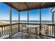 Screened-in porch with ocean views and outdoor seating, perfect for enjoying the coastal breeze at 108 N Ocean Blvd. # 308, North Myrtle Beach, SC 29582