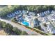 Aerial view showcasing the condo complex, pool, lush trees, and surrounding area at 10970 Highway 90 # A5, Little River, SC 29566