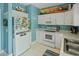 Efficient kitchen features white appliances, white cabinets, and coastal-themed accents at 10970 Highway 90 # A5, Little River, SC 29566
