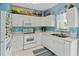 Compact kitchen with white cabinetry, modern appliances, and bright, colorful decor at 10970 Highway 90 # A5, Little River, SC 29566