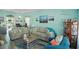 Cozy living room with a nautical design, comfortable seating, and coastal artwork at 10970 Highway 90 # A5, Little River, SC 29566
