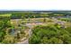 New home construction is underway in this aerial view of a property with ponds and trees surrounding it at 1127 Crooked Hook Rd., North Myrtle Beach, SC 29582