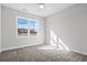Comfortable carpeted bedroom is bright and airy with a window and ceiling fan at 1127 Crooked Hook Rd., North Myrtle Beach, SC 29582