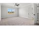 Bedroom with plush carpet, ceiling fan, window with view, and an ensuite bathroom at 1127 Crooked Hook Rd., North Myrtle Beach, SC 29582