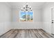Well-lit dining room features stylish chandelier, wainscoting, and beautiful natural light at 1127 Crooked Hook Rd., North Myrtle Beach, SC 29582
