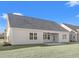 New home exterior featuring a concrete patio and lush green lawn at 1127 Crooked Hook Rd., North Myrtle Beach, SC 29582