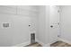 Neat laundry room featuring washer hookups, wire shelving, and a utility sink at 1127 Crooked Hook Rd., North Myrtle Beach, SC 29582