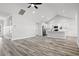 Spacious, light-filled living area flows into a kitchen with modern appliances and wood flooring at 1127 Crooked Hook Rd., North Myrtle Beach, SC 29582