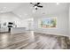 Bright, open-concept living space with wood floors, vaulted ceiling, and seamless kitchen view at 1127 Crooked Hook Rd., North Myrtle Beach, SC 29582