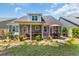 Landscaped backyard showcasing a screened porch and patio areas, ideal for outdoor relaxation and gatherings at 1136 Doubloon Dr., North Myrtle Beach, SC 29582