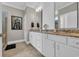 The primary bathroom showcases double vanities, white cabinetry, and granite countertops at 1136 Doubloon Dr., North Myrtle Beach, SC 29582