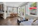 Sunlit dining room boasts a fireplace, hardwood floors, modern lighting, and a white sofa, creating an inviting space at 1136 Doubloon Dr., North Myrtle Beach, SC 29582