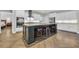 A modern kitchen features a large island with seating, stainless steel appliances, and white cabinets at 1136 Doubloon Dr., North Myrtle Beach, SC 29582