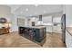 The open kitchen has white cabinets, a black island with seating, and modern stainless steel appliances at 1136 Doubloon Dr., North Myrtle Beach, SC 29582