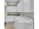 The bright laundry room features white cabinets, granite countertops, and a modern washer/dryer at 1136 Doubloon Dr., North Myrtle Beach, SC 29582