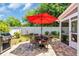 Charming outdoor patio featuring a dining set, grill, and shade umbrella, perfect for entertaining at 1136 Doubloon Dr., North Myrtle Beach, SC 29582