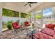 Inviting screened porch featuring comfortable seating, ceiling fan, and views of the landscaped backyard at 1136 Doubloon Dr., North Myrtle Beach, SC 29582