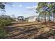 Expansive backyard with lush greenery and a wrought-iron fence at 1196 Fiddlehead Way, Myrtle Beach, SC 29579