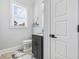 Powder room features a dark vanity, marble floors, and a toilet at 1196 Fiddlehead Way, Myrtle Beach, SC 29579
