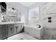 Bathroom featuring a tub, shower, vanity, and marble tile at 1196 Fiddlehead Way, Myrtle Beach, SC 29579