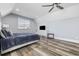 Bedroom with vaulted ceiling features hardwood floors, fan and tv at 1196 Fiddlehead Way, Myrtle Beach, SC 29579