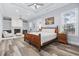 Inviting bedroom with tray ceilings, a fireplace, a ceiling fan, and large windows for plenty of natural light at 1196 Fiddlehead Way, Myrtle Beach, SC 29579