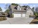 Well-manicured home exterior with a three-car garage and manicured landscaping at 1196 Fiddlehead Way, Myrtle Beach, SC 29579