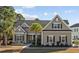 Charming single-story home with neutral siding, a palm tree, manicured landscaping, and a cozy, inviting entrance at 1196 Fiddlehead Way, Myrtle Beach, SC 29579