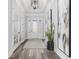 Inviting foyer featuring a decorative front door, trey ceiling, sleek flooring, and elegant decor at 1196 Fiddlehead Way, Myrtle Beach, SC 29579