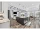 Open-concept kitchen with decorative ceiling, large island, stainless appliances, and adjacent dining and living areas at 1196 Fiddlehead Way, Myrtle Beach, SC 29579