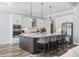 Bright kitchen boasts white cabinets, stainless steel appliances, and a large center island with counter seating at 1196 Fiddlehead Way, Myrtle Beach, SC 29579